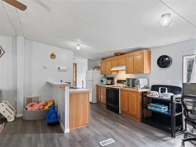 a kitchen with stainless steel appliances granite countertop a stove and a refrigerator