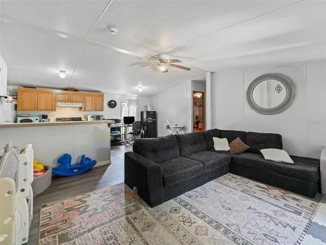 a living room with furniture and kitchen view
