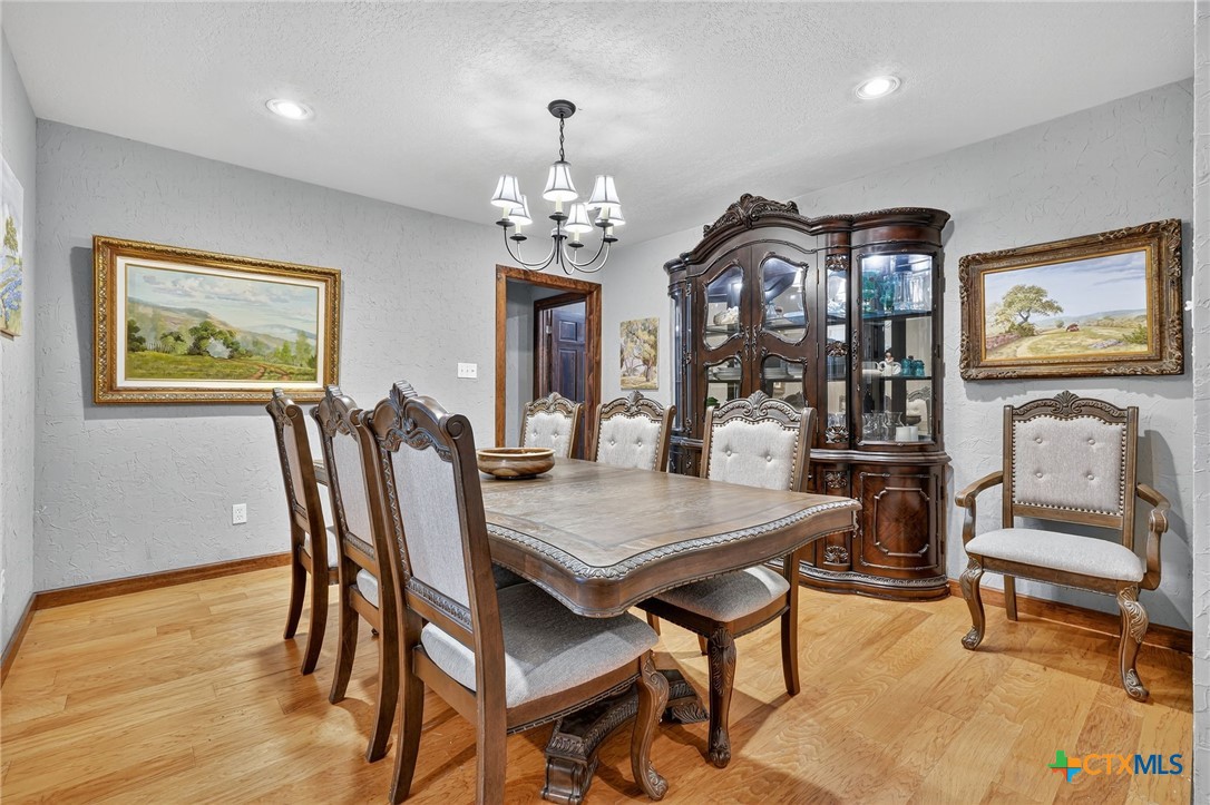 725 County Road 300 Hamilton, TX 76531 - Photo 13 of 41 a view of a dining room with furniture and wooden floor