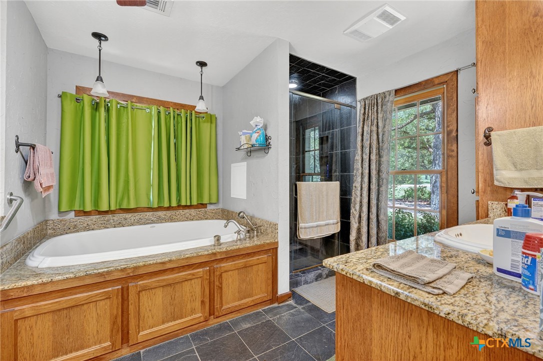 725 County Road 300 Hamilton, TX 76531 - Photo 26 of 41 a bathroom with a granite countertop sink and a large mirror
