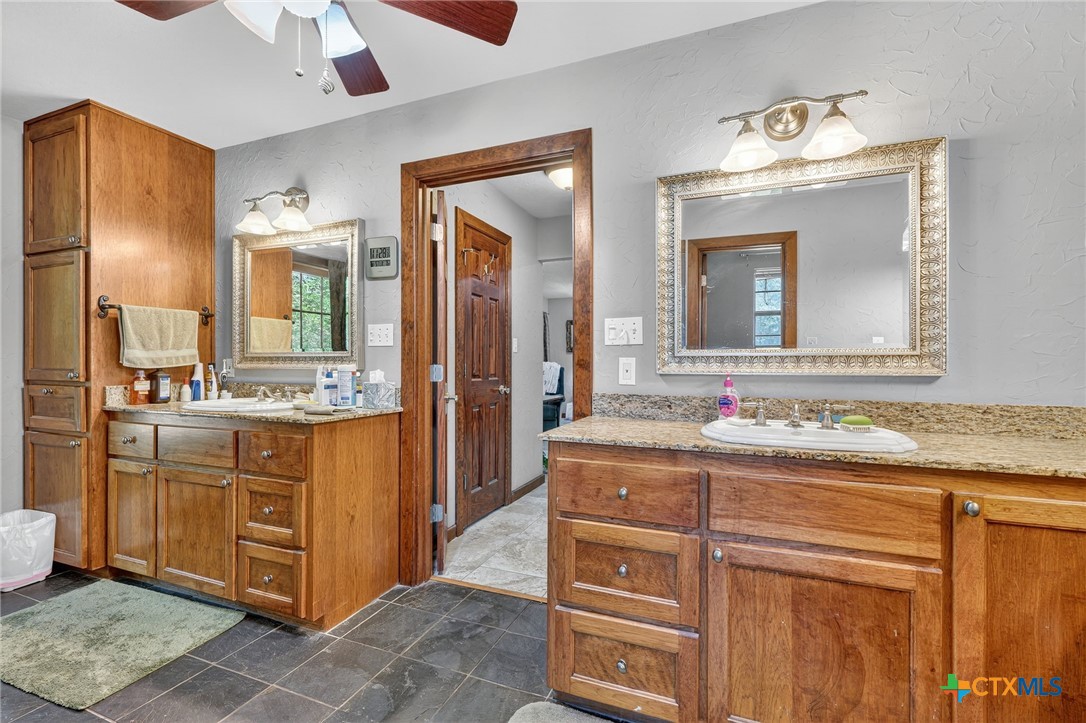 725 County Road 300 Hamilton, TX 76531 - Photo 27 of 41 a bathroom with a granite countertop sink mirror and double