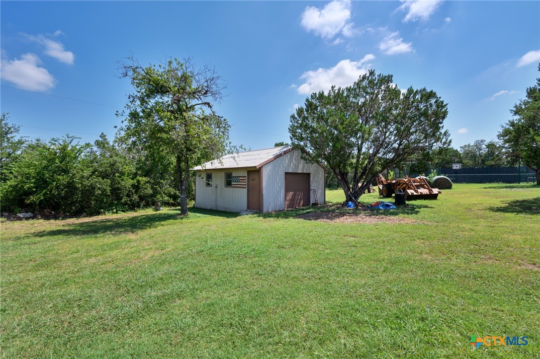 725 County Road 300 Hamilton, TX 76531 - Photo 32 of 41 a yellow house with garden in front of it