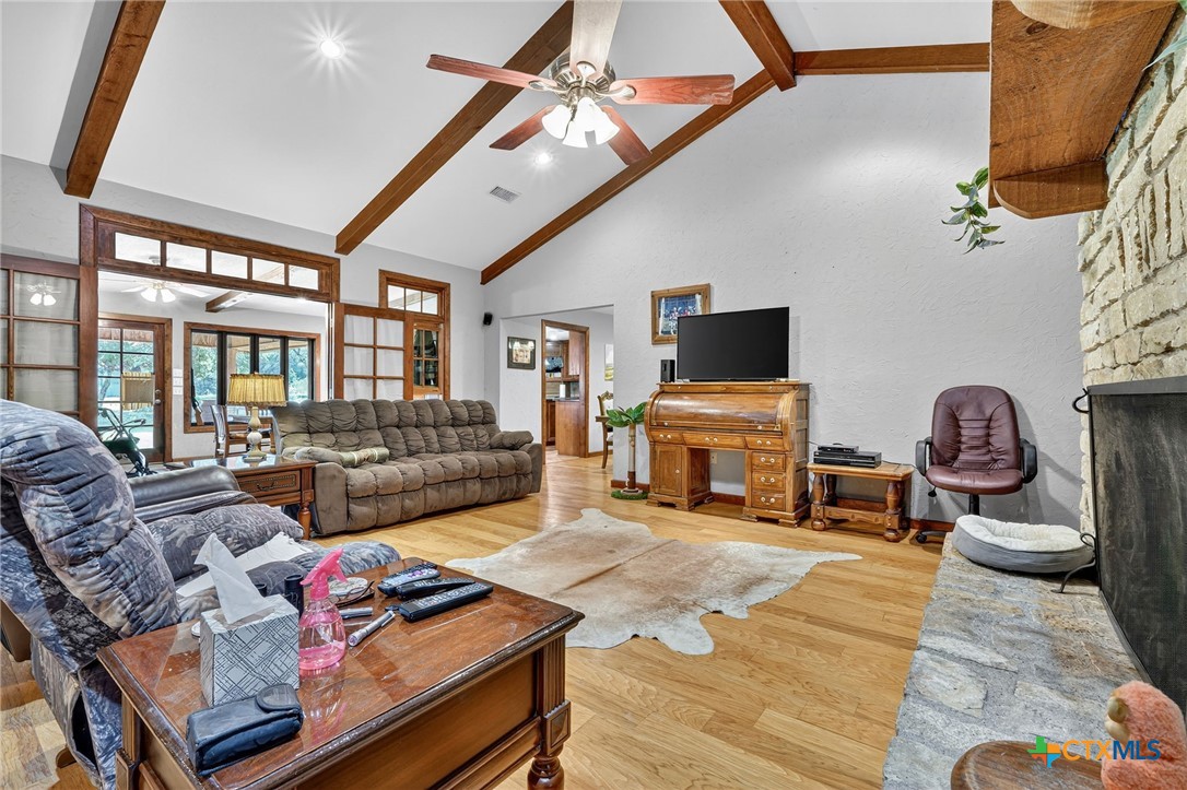 725 County Road 300 Hamilton, TX 76531 - Photo 6 of 41 a living room with furniture a fireplace and a flat screen tv