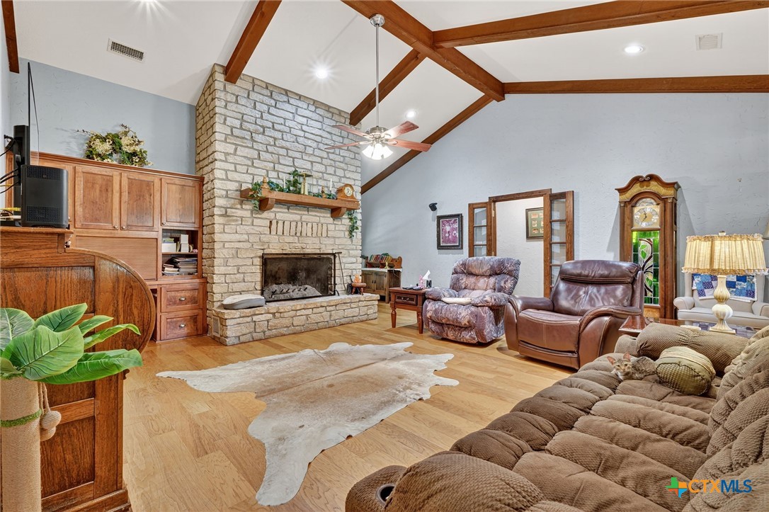 725 County Road 300 Hamilton, TX 76531 - Photo 8 of 41 a living room with furniture a fireplace and a flat screen tv