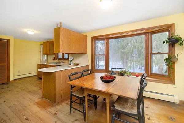 a view of a dining room with furniture and window