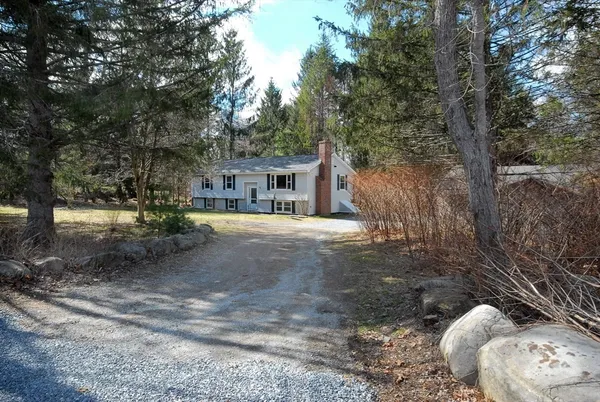 a view of a house with a snow in the yard