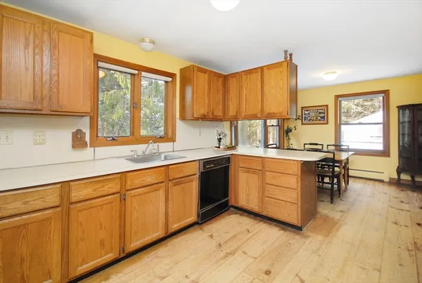 a kitchen with cabinets a sink and appliances