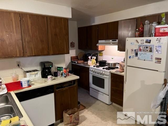 6797 Flower Street Reno, NV 89506 - Photo 3 of 7 a kitchen with a sink stove and cabinets