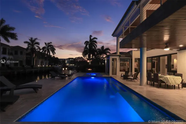 an aerial view of residential house with outdoor space and lake view