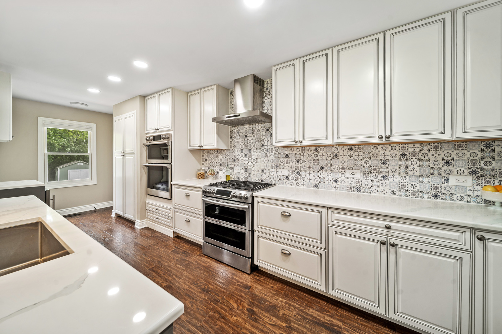 28W140 Mack Road Wheaton, IL 60189 - Photo 10 of 48 a kitchen with granite countertop white cabinets and stainless steel appliances