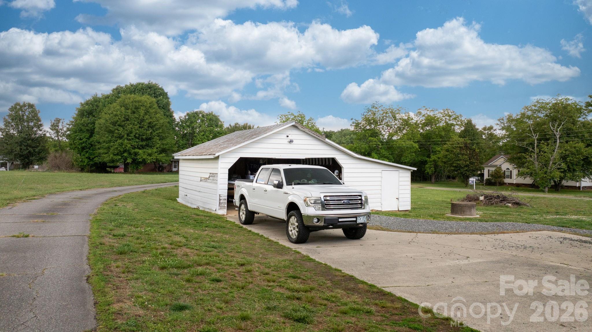 3941 Springs Road Northeast Conover, NC 28613 - Photo 18 of 21 a car parked in front of white house