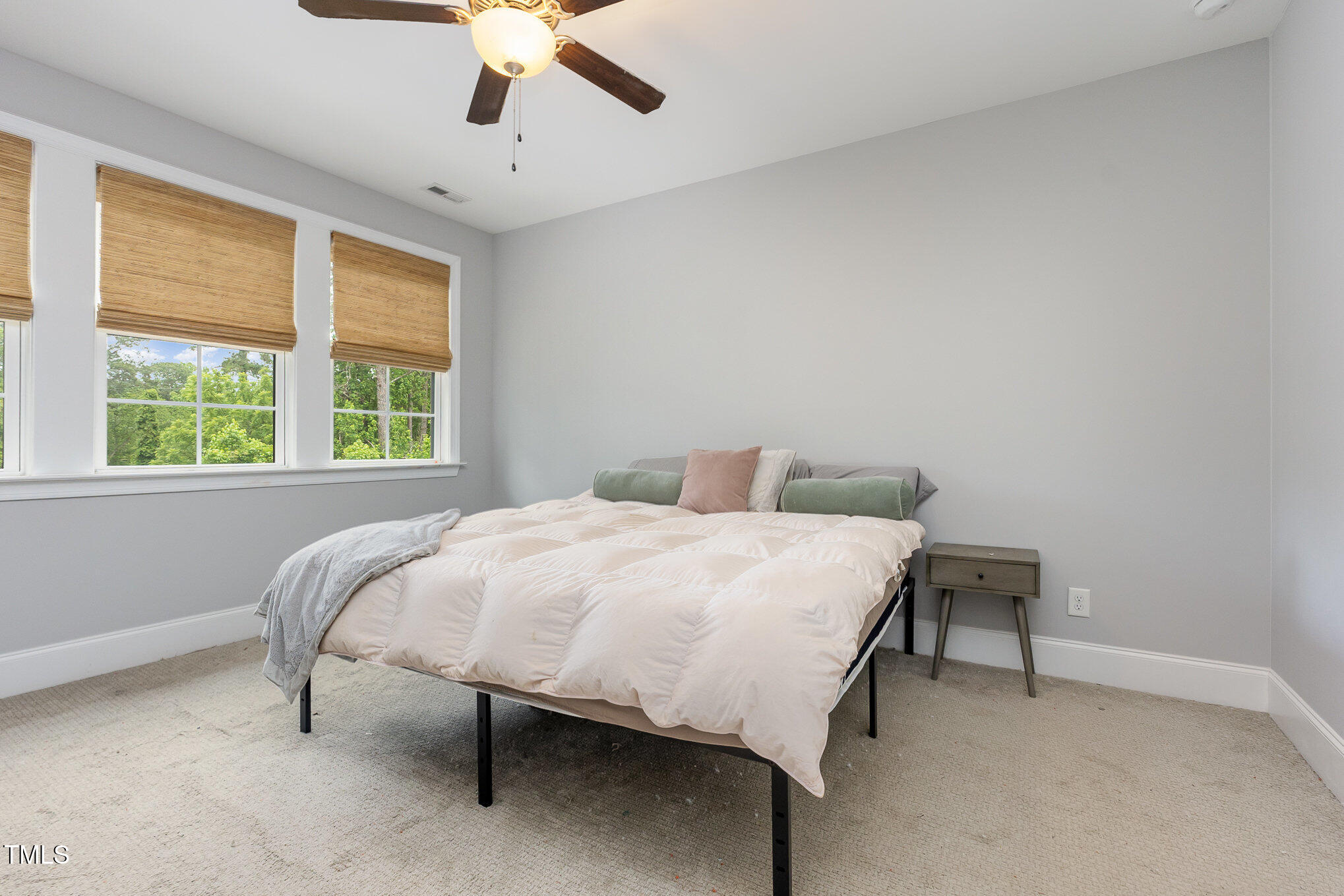 Undisclosed Address Raleigh, NC 27607 - Photo 7 of 15 a large bed sitting in a bedroom next to a window