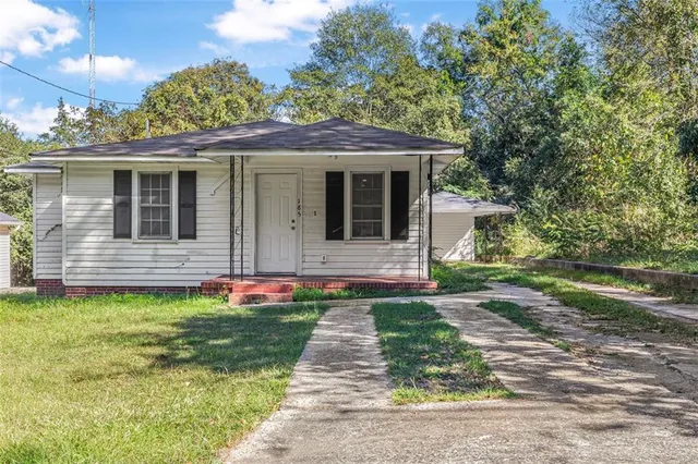 a front view of a house with garden