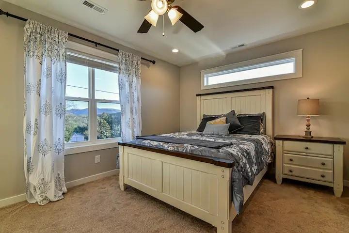664 Old Fort Road Fairview, NC 28730 - Photo 12 of 20 a bedroom with a large bed and a chandelier fan