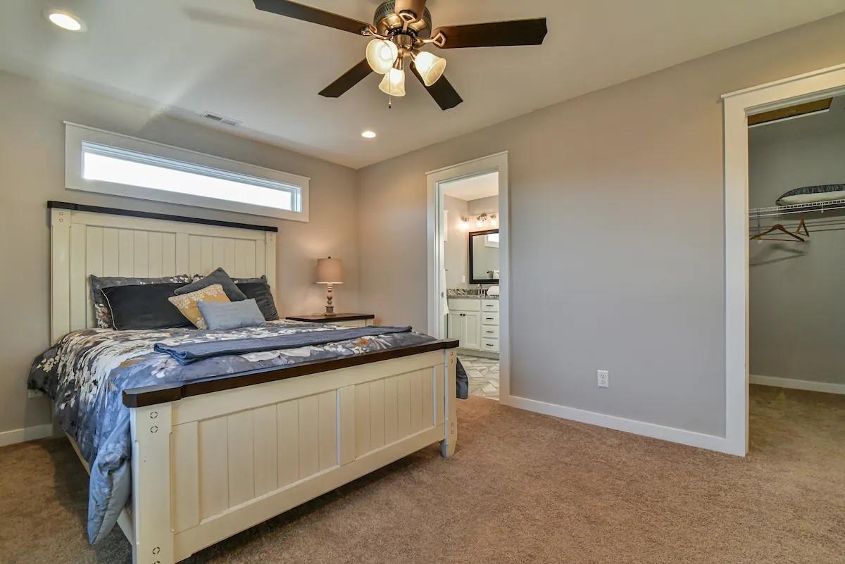 664 Old Fort Road Fairview, NC 28730 - Photo 13 of 20 a bed room with a bed and a chandelier