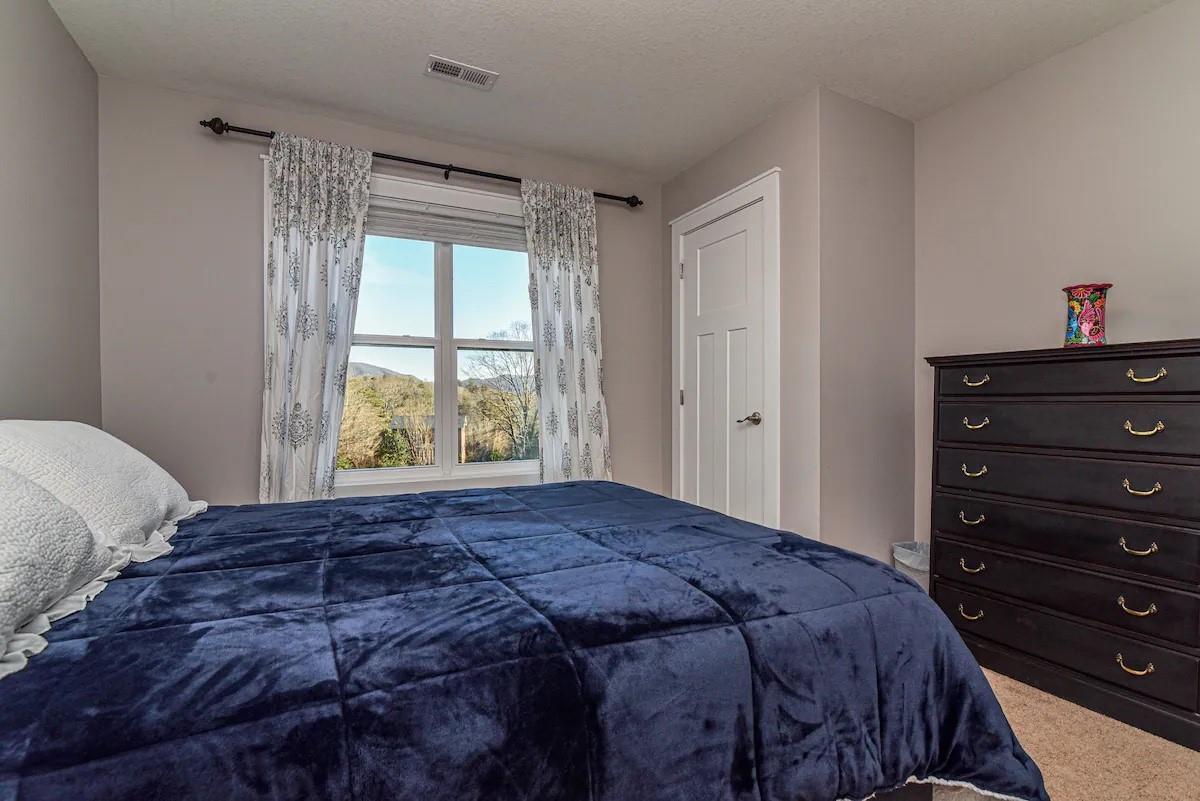 664 Old Fort Road Fairview, NC 28730 - Photo 15 of 20 a bedroom with a bed and a window