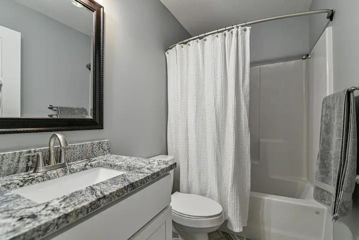 664 Old Fort Road Fairview, NC 28730 - Photo 17 of 20 a bathroom with a granite countertop sink toilet and shower