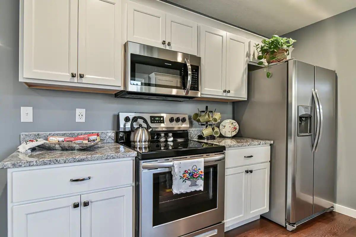 664 Old Fort Road Fairview, NC 28730 - Photo 8 of 20 a kitchen with stainless steel appliances granite countertop a refrigerator stove and sink with wooden floor