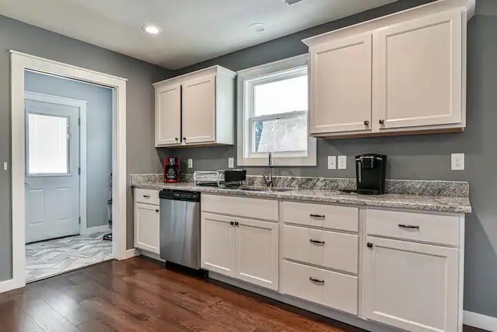 664 Old Fort Road Fairview, NC 28730 - Photo 10 of 20 a kitchen with granite countertop white cabinets and a stainless steel appliances