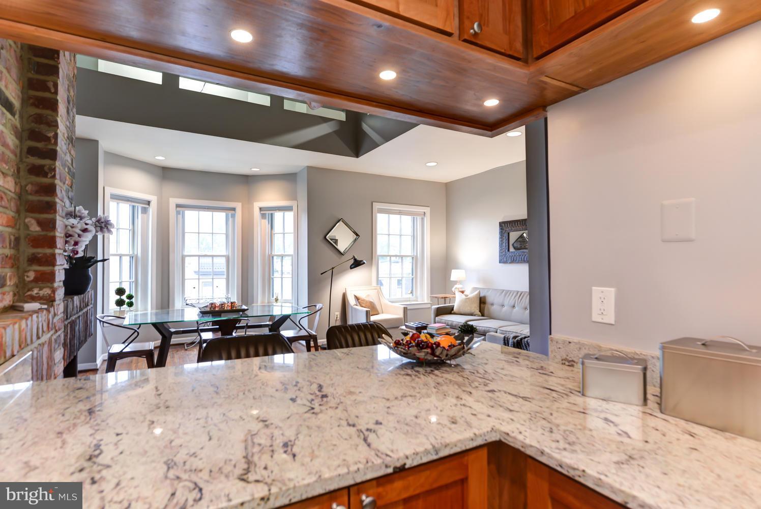 309 4th Street Southeast, Unit 6 Washington, DC 20003 - Photo 16 of 27 open kitchen bar into living room and dining