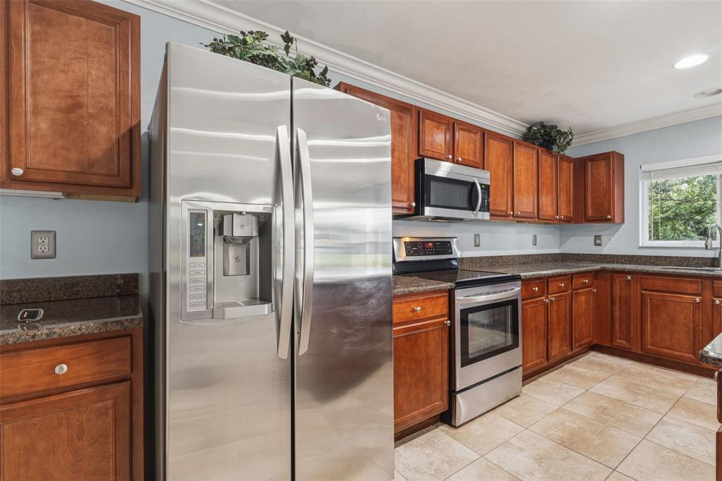 25134 Palisade Road Punta Gorda, FL 33983 - Photo 26 of 58 a kitchen with stainless steel appliances granite countertop a refrigerator and a stove top oven