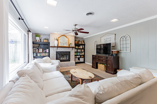 1904 Robert Drive Champaign, IL 61821 - Photo 11 of 131 a living room with furniture a fireplace and a flat screen tv