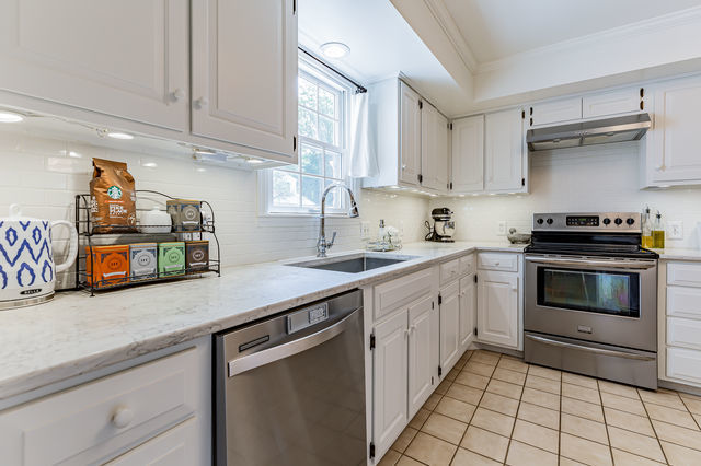 1904 Robert Drive Champaign, IL 61821 - Photo 17 of 131 a kitchen with stainless steel appliances a stove sink and cabinets