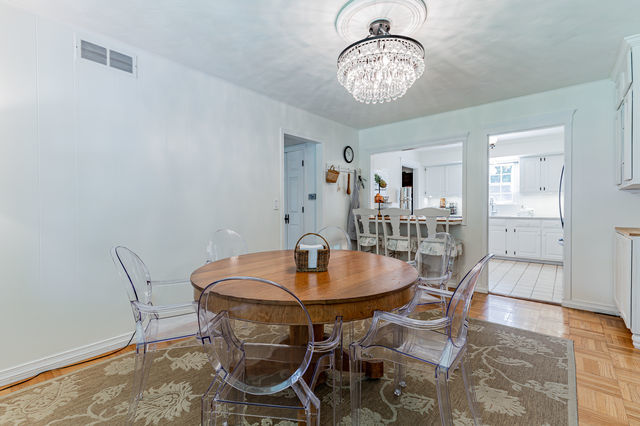 1904 Robert Drive Champaign, IL 61821 - Photo 26 of 131 a view of a dining room with furniture and chandelier