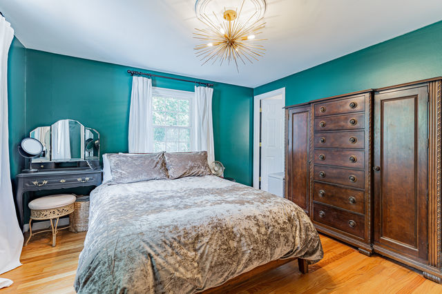 1904 Robert Drive Champaign, IL 61821 - Photo 39 of 131 a bedroom with a bed and a chandelier