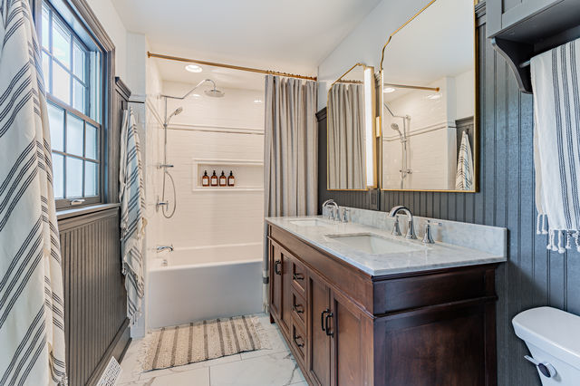 1904 Robert Drive Champaign, IL 61821 - Photo 40 of 131 a bathroom with a sink a mirror and a bathtub