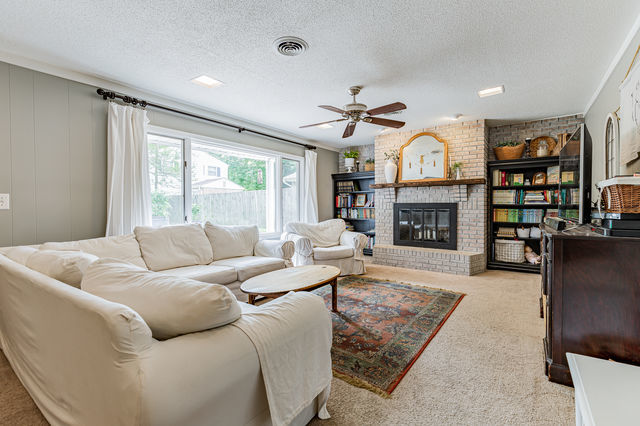 1904 Robert Drive Champaign, IL 61821 - Photo 10 of 131 a living room with furniture fireplace and a flat screen tv