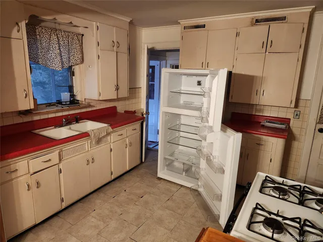 a kitchen with cabinets and window