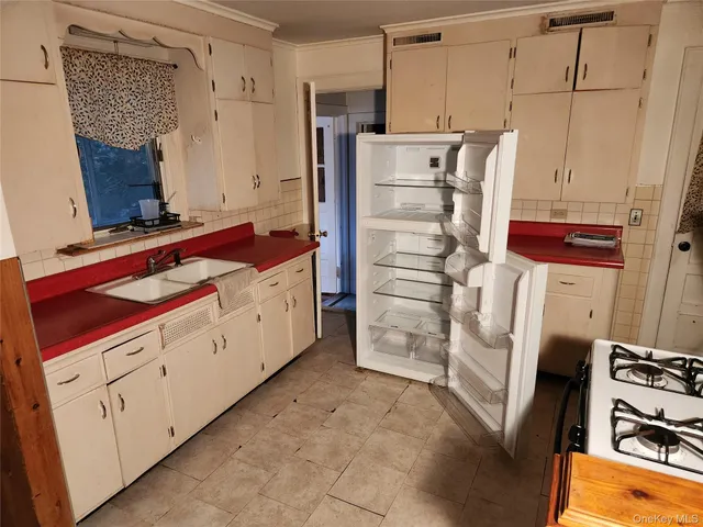 a kitchen with stainless steel appliances a stove and a refrigerator