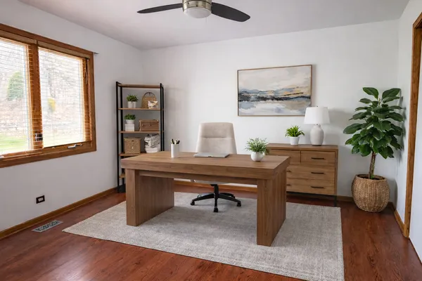 a view of a workspace with furniture and a potted plant