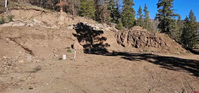 a view of a yard with wooden fence
