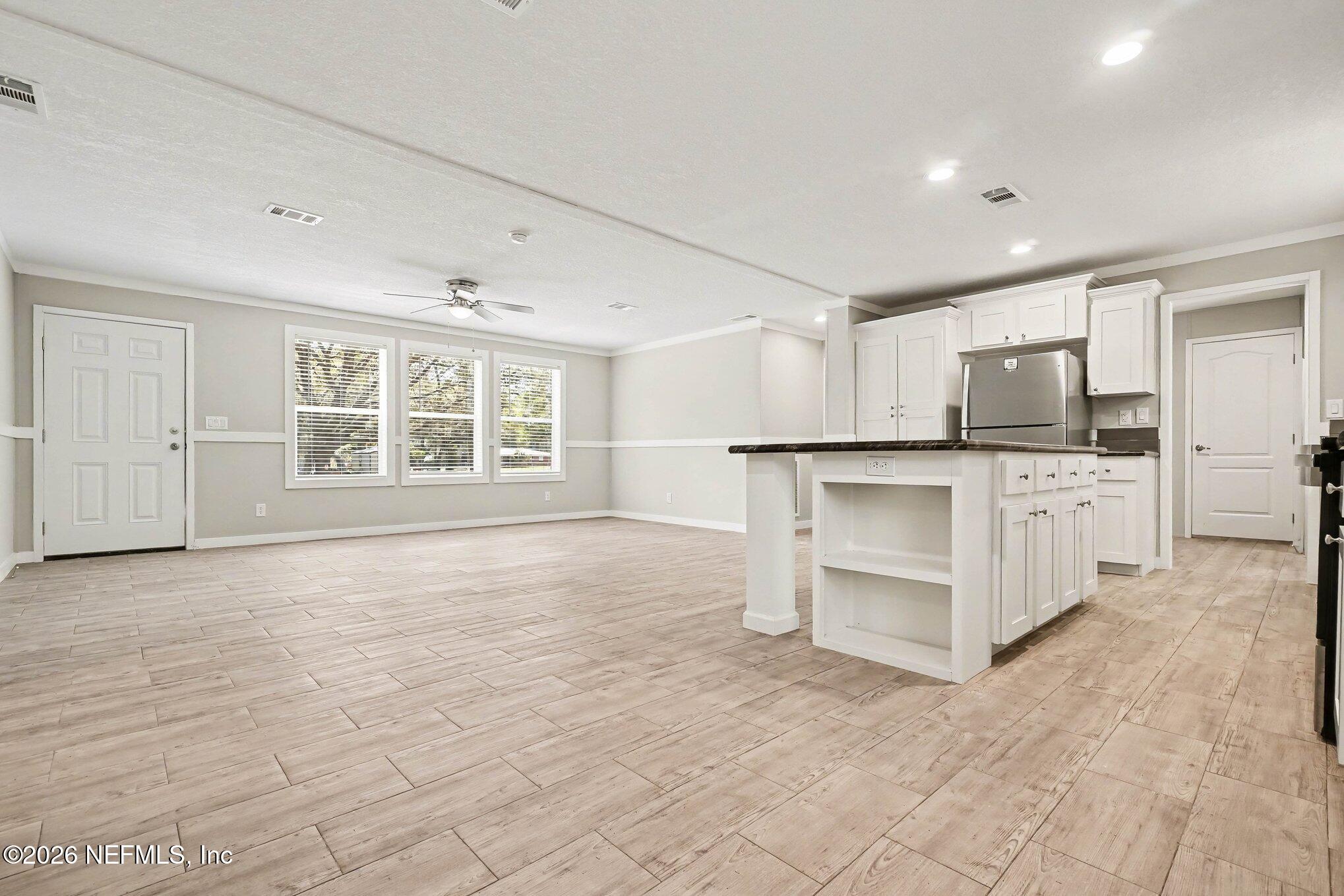 85083 Condor Lane Yulee, FL 32097 - Photo 11 of 32 a large white kitchen with granite countertop a stove a sink and a refrigerator