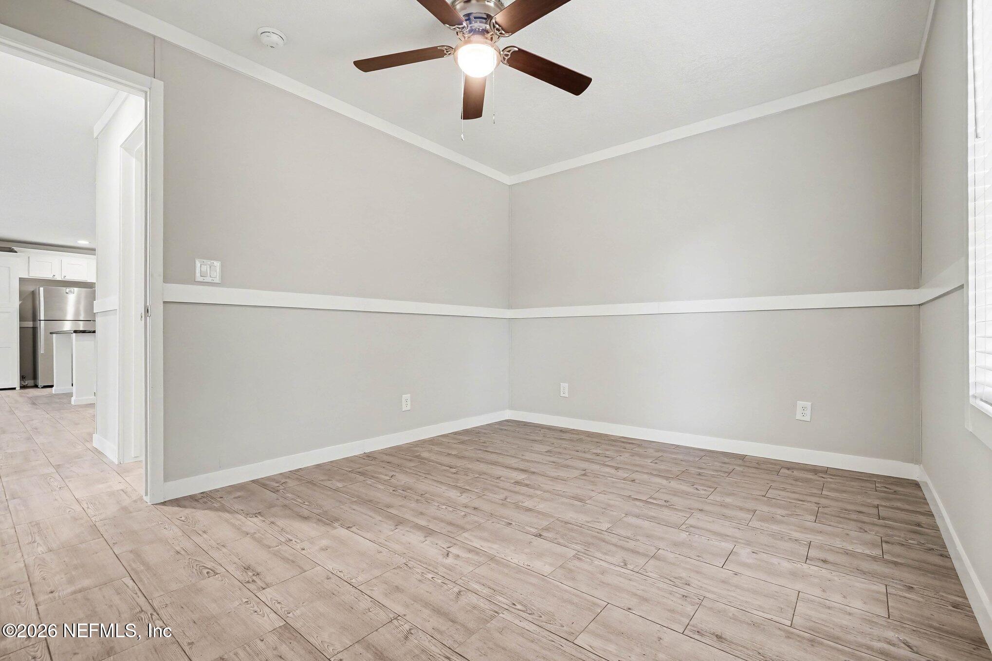 85083 Condor Lane Yulee, FL 32097 - Photo 15 of 32 wooden floor in an empty room with a window