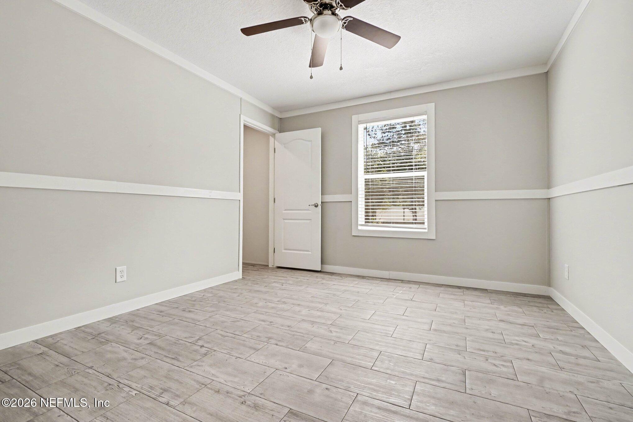 85083 Condor Lane Yulee, FL 32097 - Photo 21 of 32 a view of an empty room with a window