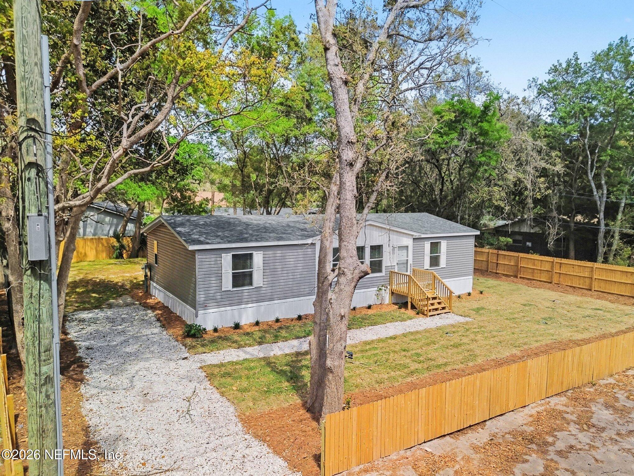 85083 Condor Lane Yulee, FL 32097 - Photo 29 of 32 a view of a house with trees in the background