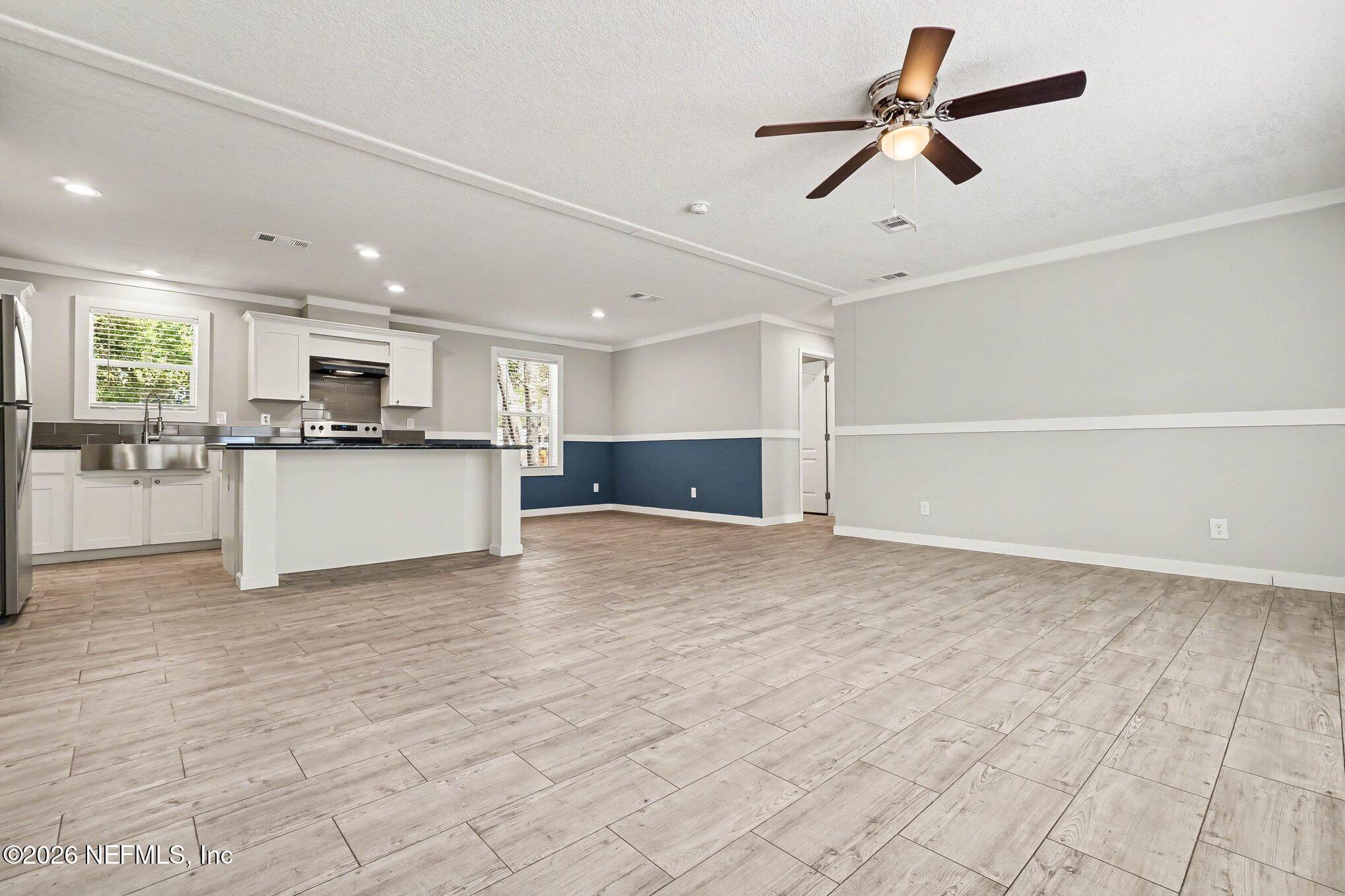85083 Condor Lane Yulee, FL 32097 - Photo 3 of 32 a view of kitchen with stainless steel appliances granite countertop a refrigerator and microwave