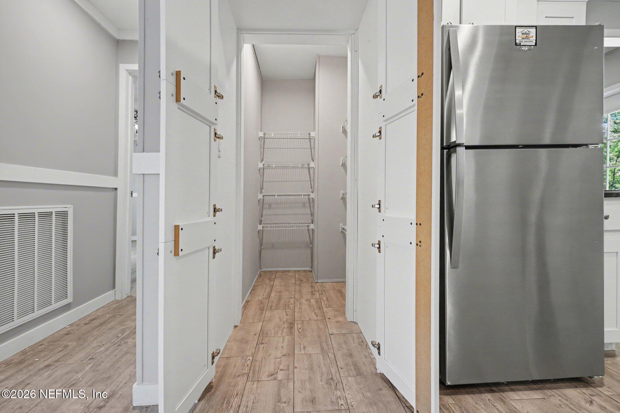 85083 Condor Lane Yulee, FL 32097 - Photo 5 of 32 a view of a hallway with a refrigerator