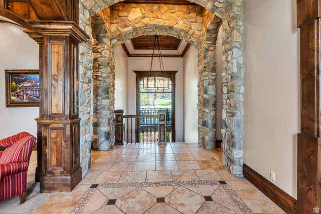 811 South High Ridge Drive Alpine, UT 84004 - Photo 9 of 98 Hall featuring arched walkways, crown molding, and inlaid floor details