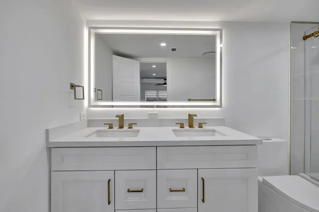 a bathroom with a sink toilet tub and shower