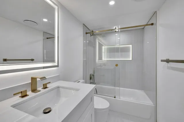 a bathroom with a sink vanity and mirror
