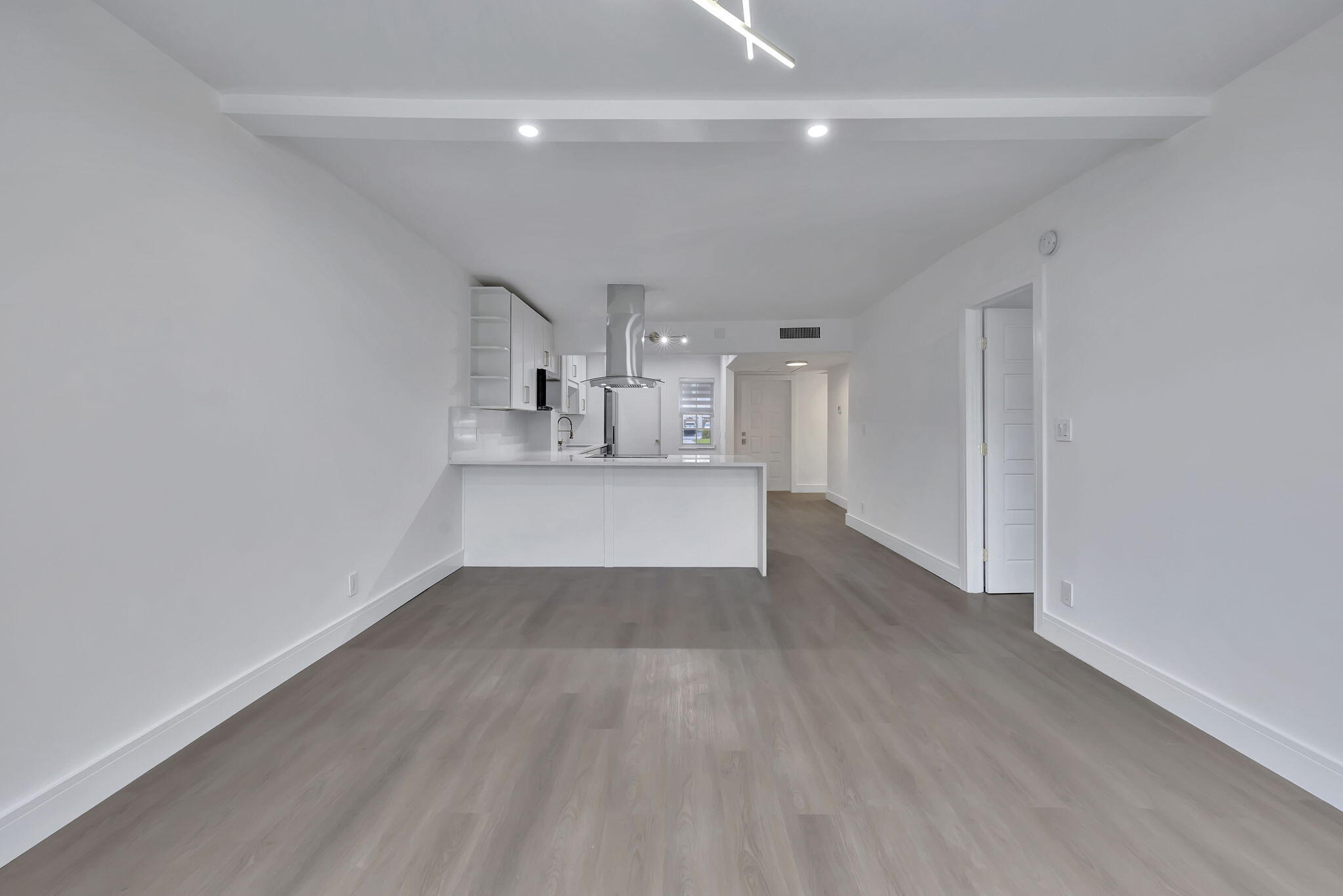 3100 North Palm Aire Drive, Unit 106 Pompano Beach, FL 33069 - Photo 10 of 42 a view of a hallway with wooden floor