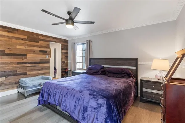 a bedroom with a bed and wooden floor