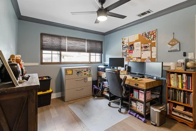 a view of a workspace with furniture and a window