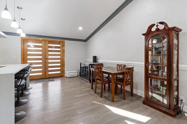 a view of a a dining room with furniture window and wooden floor