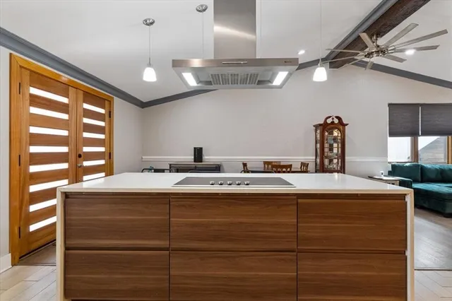 a view of a kitchen counter top a stove and furniture
