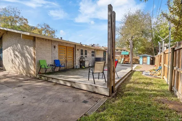 a view of a porch with furniture and a yard